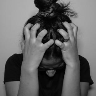 Woman with her head in her hands