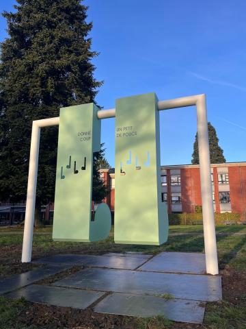 Back of swing with words inscribed "lend a little helping hand" in French